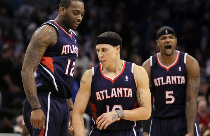 Atlanta Hawks center Josh Powell (12), point guard Mike Bibby (10), and power forward Josh Smith (5) react during the second half against the Orlando Magic at Amway Center. Atlanta Hawks defeated the Orlando Magic 80-74.